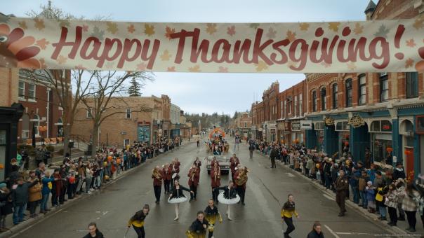 Thanksgiving parade on the street with huge banner